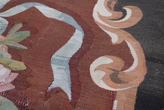 An Aubusson rug with central floral motif on a brown field 170 x 220cm